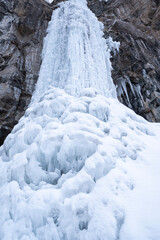 Winter landscape in the mountains near Almaty, Kazakhstan. View of the frozen Butakovskiy waterfall in the mountains.