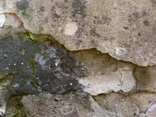 Old stone wall with lichen moss and textured natural surface pattern