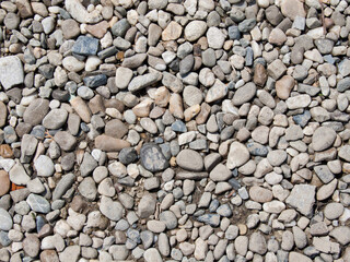 Stone pebble textured wall pattern on beach background
