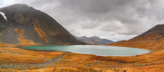 Russia. Mountain Altai. Junkel Lake. Lake with turquoise water against the backdrop of a mountain range.