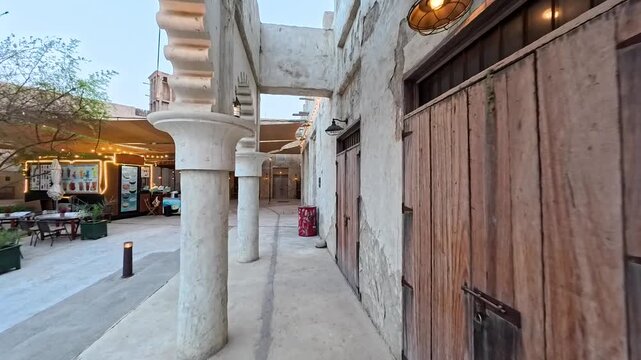 Dubai, UAE, 28.05.2025. Al Seef Dubai Creek historical heritage Area or Dubai Old City and Al Seef Marine boats Yacht. Vintage Vibe of the traditional arab architecture