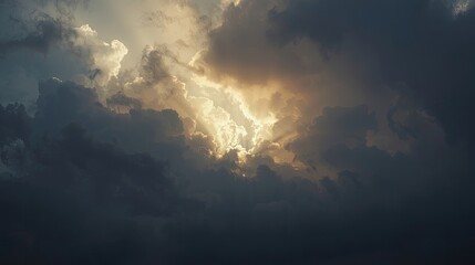 A dramatic sky scene showcases a sunlit break through dense, dark clouds.