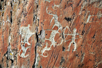 Russia. Altai Mountains. Ancient rock painting of a hunter with a bow.