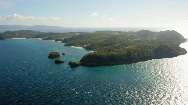 Aerial view of a tropical island with lush green vegetation and turquoise waters