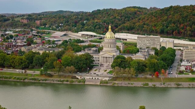The west virginia state capitol building stands tall along the kanawha river