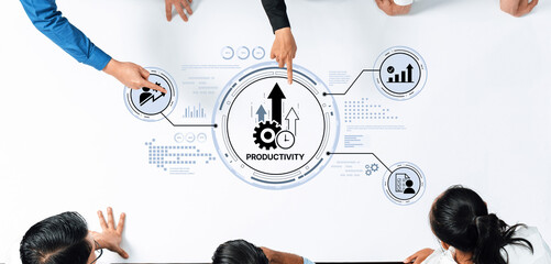 A top-down view of a team engaged in a business meeting with a focus on productivity improvements through visual data analysis and collaborative discussion on strategies. Trope