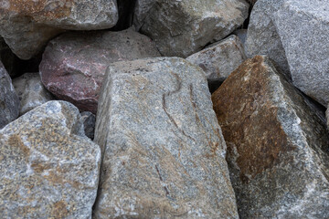 Close-up view of large natural rocks with rough textures and different colors