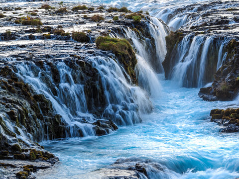 Cascading Blue Water of Br&uacute;arfoss Waterfall Flowing Over Jagged Rock Formations in the Golden Circle, Iceland.