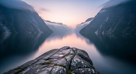 Tranquil Water Reflects Majestic Mountains Under Soft Morning Light