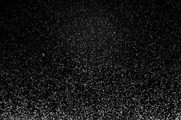 Black and white abstract image resembling snowfall at night or a starry sky, with countless white specks scattered across a dark background.