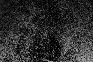 Black and white abstract image resembling snowfall at night or a starry sky, with countless white...