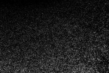 Black and white abstract image resembling snowfall at night or a starry sky, with countless white...