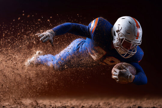 A football player is running with a football in his hand