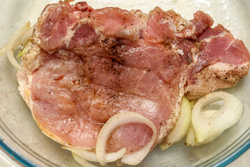 Raw meat marinated with onions before frying.