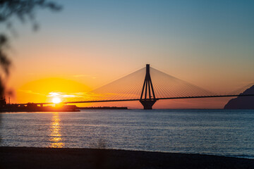 View of the bridge Rio-Antirio, Charilaos Trikoupis in Greece, at sunset.