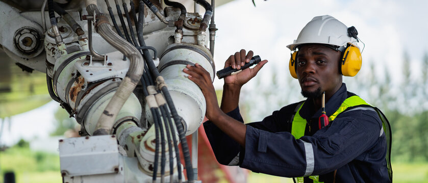 Aircraft maintenance engineer inspecting airplane engine with safety equipment and tools, aviation mechanic ensuring aircraft repair, safety check, and technical engineering service.