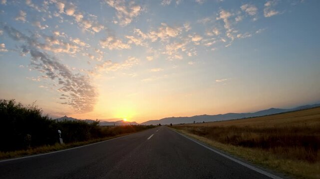 Sunset nature, golden valley and beautiful sparse clouds sky scenery, POV drive