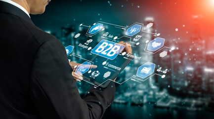 A business professional interacts with a digital interface showcasing various icons and graphics,...