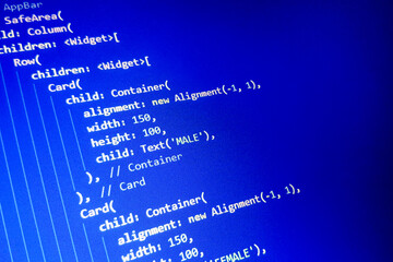 Close-up view of computer code on a blue background, featuring widget definitions and alignment properties. Ideal for technology and programming themes.