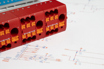 Red industrial terminal block on circuit diagram
