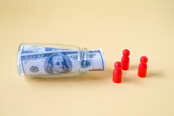 Wooden figure standing to Bank notes in a glass jar. Money Saving, Financial Planning and Economy Concept.