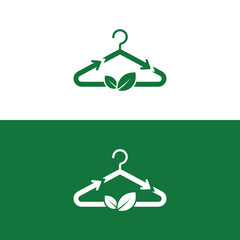 Green clothing hanger with recycling arrows and natural leaves representing sustainable fashion.