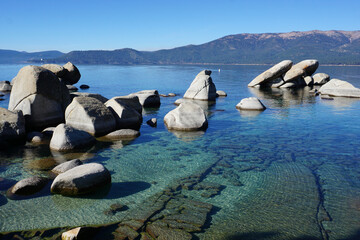 panoramic view of clear water, rocks and sand in beautiful lake Tahoe, Ca, USA, on a sunny day in Sand harbor