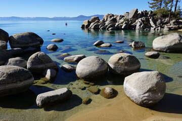 panoramic view of clear water, rocks and sand in beautiful lake Tahoe, Ca, USA, on a sunny day in Sand harbor