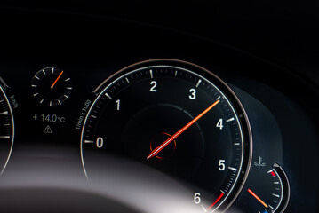Close up view of the BMW X4 instrument cluster showing the tachometer at 4000 RPM, external temperature at 14.0degC, and part of the coolant gauge. © Aerial Film Studio