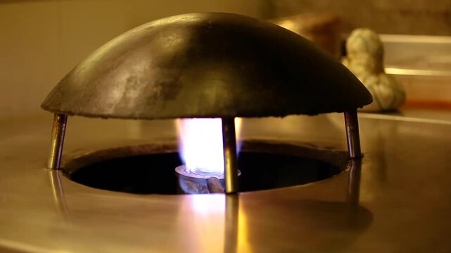 Kitchen with gas stove burning. Setup for cooking rumali roti.