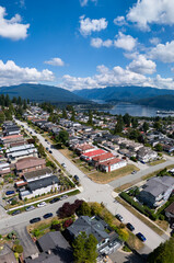 Aerial View of Burnaby Suburban Neighborhood in Greater Vancouver by Lake and Mountains