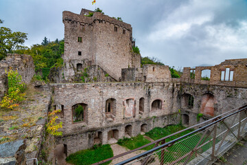 A castle ruin near Baden-Baden in Germany, with dark rain clouds in the background over the mountains