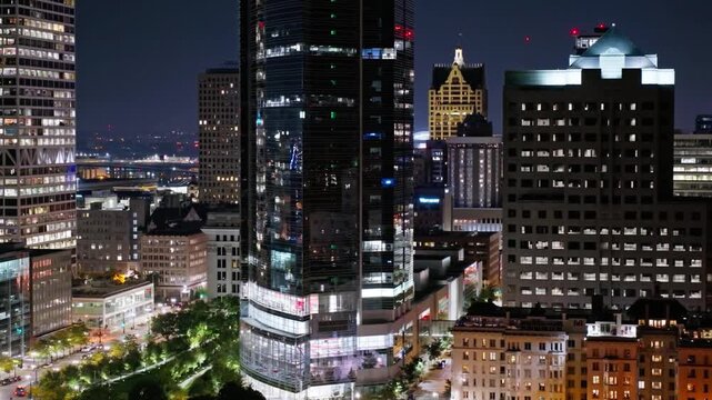 Milwaukee skyline glows at night with illuminated buildings and city lights