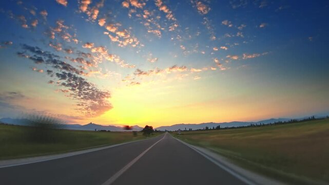 Timelapse, POV car driving across valley, trees, colorful sunset sky, clouds