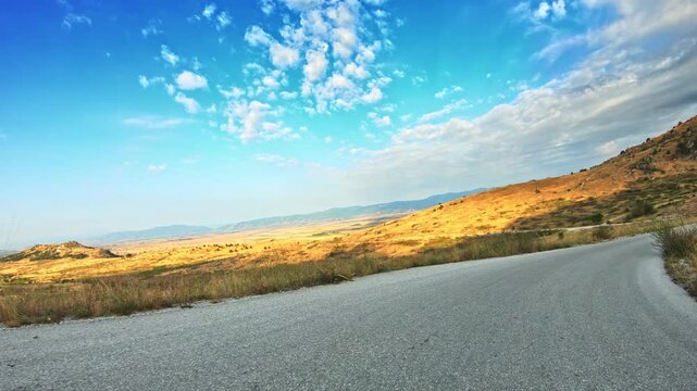 Impressive nature, POV driving downhill, beautiful blue sky clouds, sunny