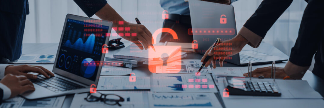 Business team engaged in a collaborative meeting, utilizing technology to analyze data while highlighting the importance of cybersecurity and data protection strategies. Trope