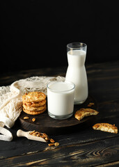 Milk and Cookies, Vertical Shot of Milk Glass, Cookies, and Bottle on Dark Background