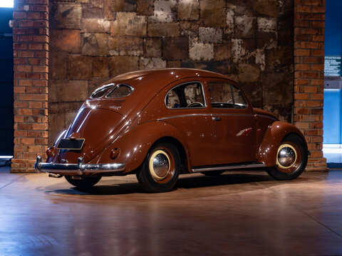 Vintage split-window Volkswagen Beetle rear view, Classic collector car in an industrial style garage

