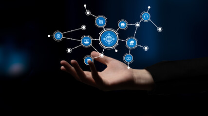 A hand reaches out toward a visual representation of a digital network, showcasing various icons related to technology and global communication against a dark background. Tessel