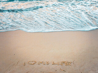 The photo shows a fragment of the beach in Sopot, Poland, where someone wrote “I ❤️ MY LIFE” in the sand.