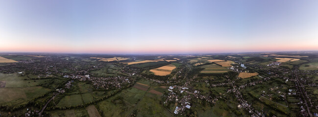 Scenic aerial countryside panorama with farmlands and villages in green summer colors