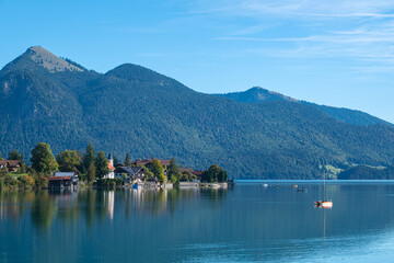 Picturesque village on the lake shore and a mountain in the European Alps