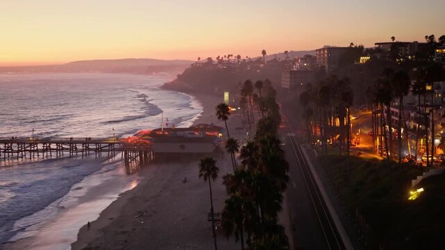 Sunset illuminates the pier and coastline of laguna beach, california