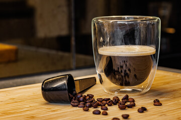 Enjoying robust espresso with vibrant dark roast coffee beans and a modern glass for a delightful morning or afternoon pick me up, perfect for lifestyle content
