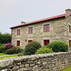 Traditional Stone House with Red Trimmed Windows