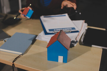 Customer signing a real estate contract in real estate agency.