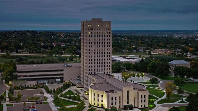 An aerial view of the north dakota state capitol building at dusk