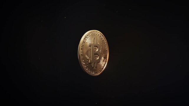 Gold Bitcoin spinning and shining with particles on a black background. 3D loop animation of BTC crypto token metal coin. Digital currency, blockchain finance money, decentralized wallet, hash mining.