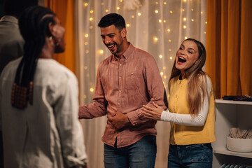 Fashion designers laughing with customer in their shop