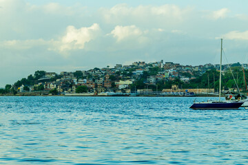 Coastal city by the sea, a harbor with boats at sunset